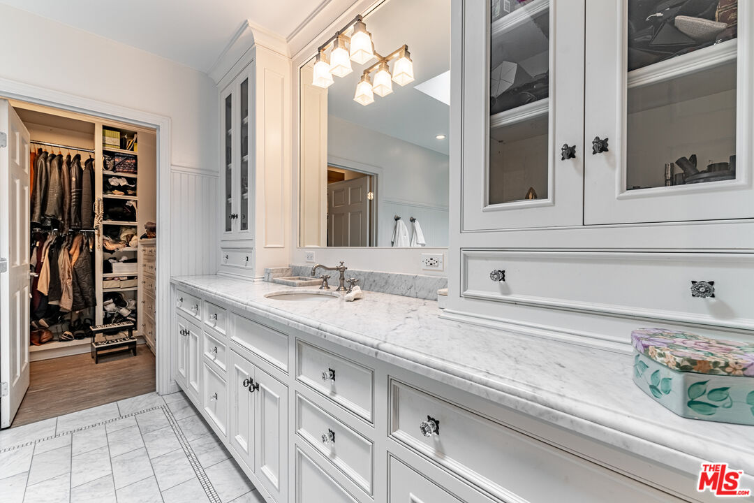 1438 San Ysidro Drive Beverly Hills, CA 90210 - Photo 24 of 40 a bathroom with a sink and a mirror