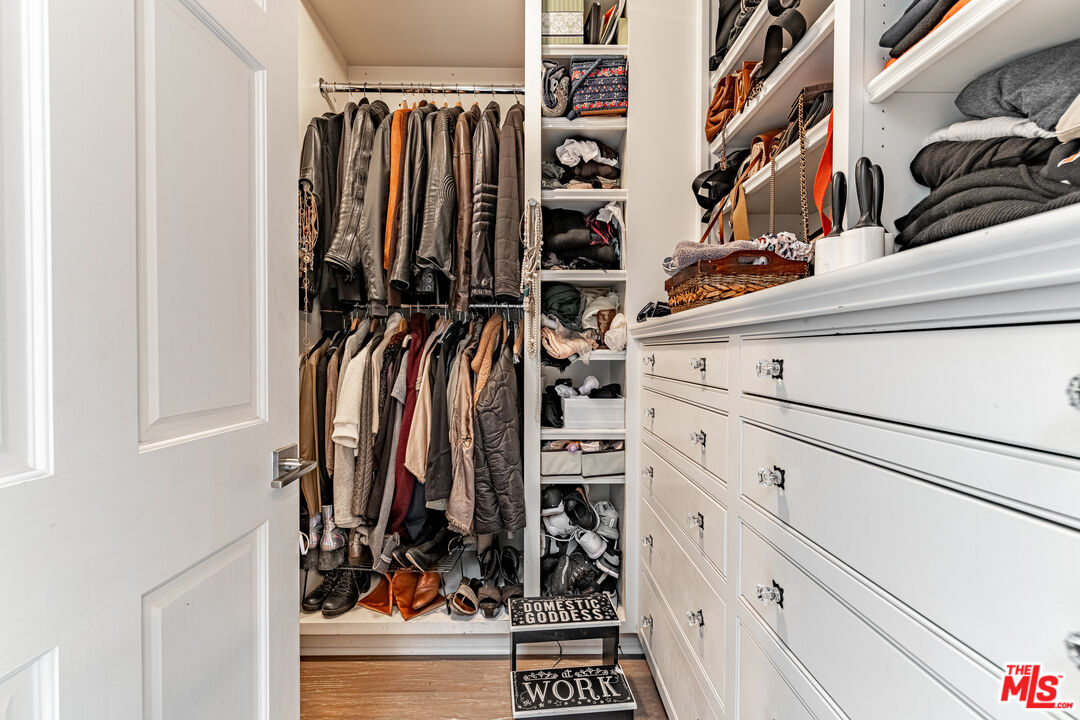1438 San Ysidro Drive Beverly Hills, CA 90210 - Photo 27 of 40 a view of walk in closet with clothes and shoes