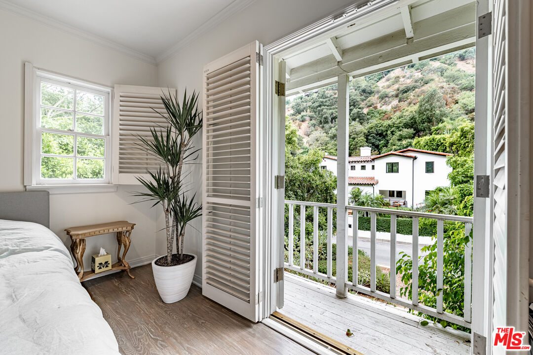 1438 San Ysidro Drive Beverly Hills, CA 90210 - Photo 29 of 40 a very nice looking room with a large window and potted plants
