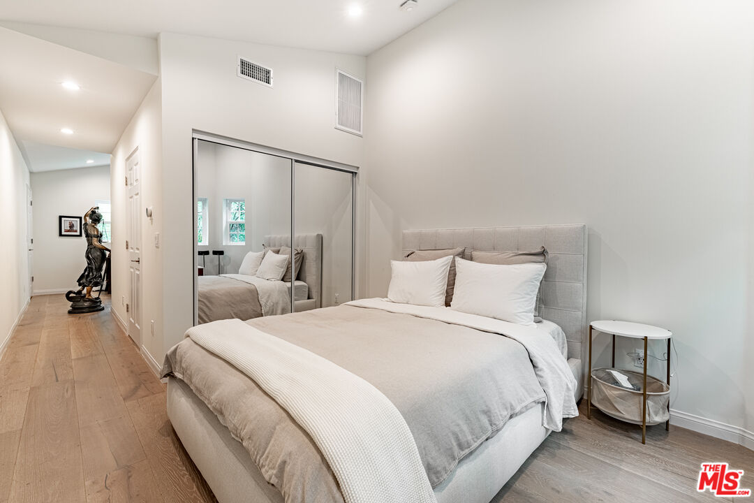 1438 San Ysidro Drive Beverly Hills, CA 90210 - Photo 35 of 40 a bed room with a bed and a large mirror