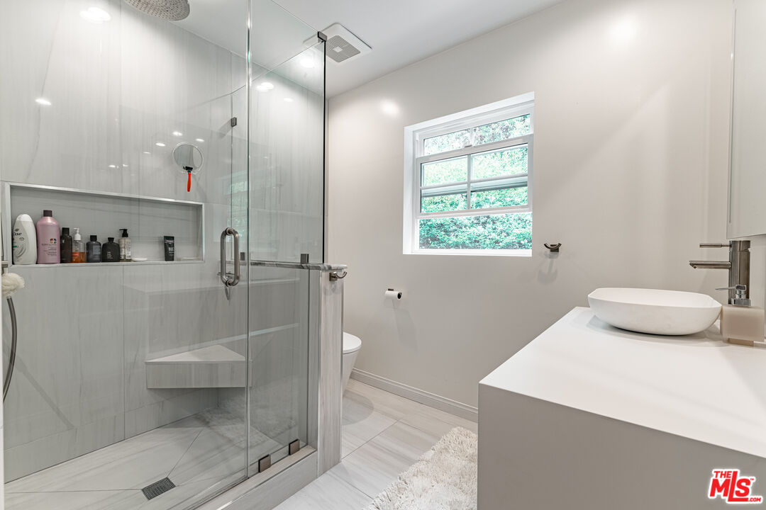1438 San Ysidro Drive Beverly Hills, CA 90210 - Photo 36 of 40 a bathroom with a sink a toilet and shower
