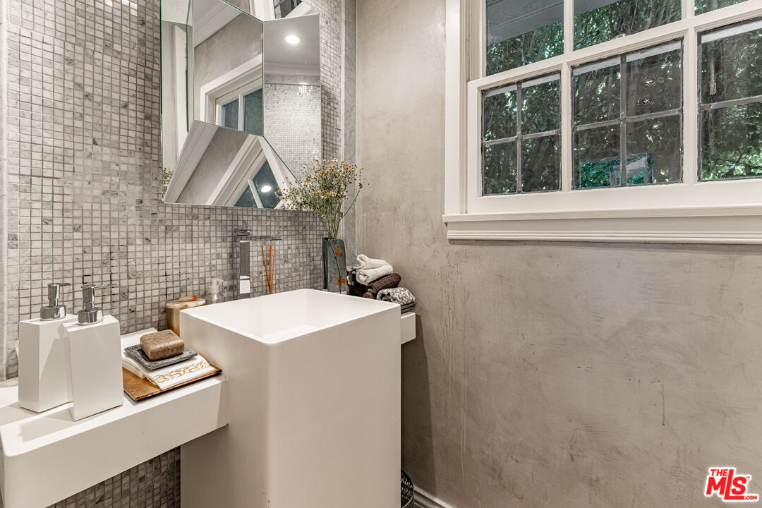 1438 San Ysidro Drive Beverly Hills, CA 90210 - Photo 38 of 40 a bathroom with a sink toilet and a mirror