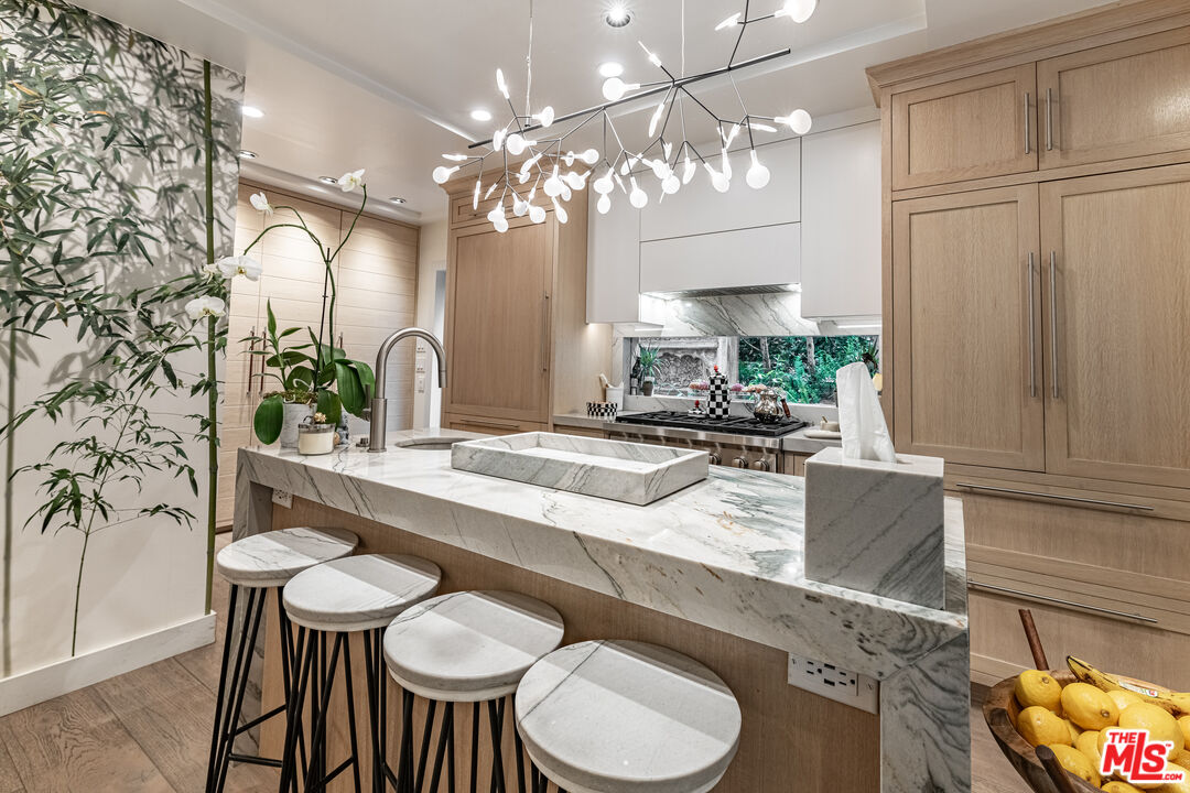 1438 San Ysidro Drive Beverly Hills, CA 90210 - Photo 7 of 40 a view of a dining room with furniture and a chandelier