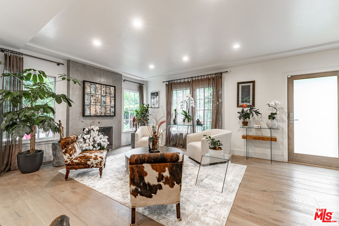 1438 San Ysidro Drive Beverly Hills, CA 90210 - Photo 9 of 40 a living room with furniture and a large window