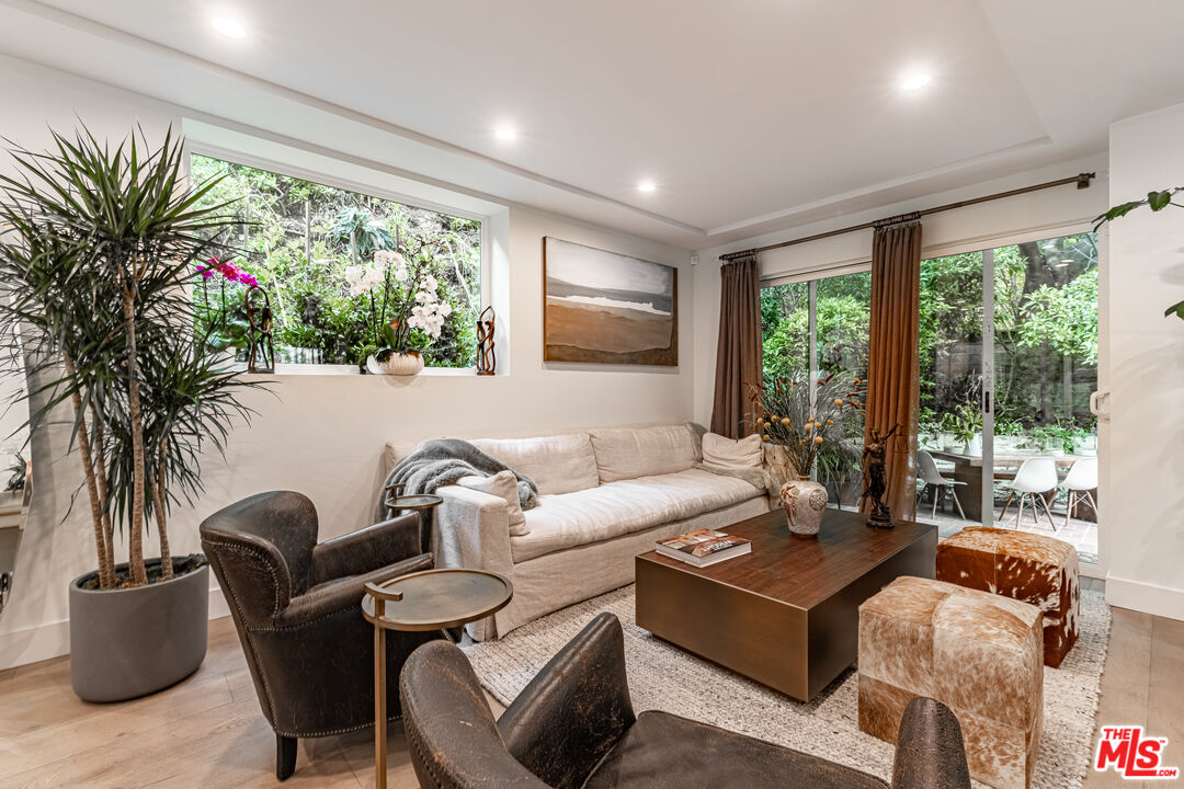 1438 San Ysidro Drive Beverly Hills, CA 90210 - Photo 10 of 40 a living room with furniture and a large window