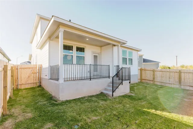 a view of a house with a backyard and deck