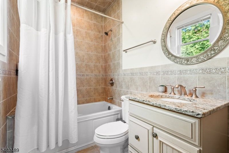 99 East Lindsley Road Cedar Grove, NJ 07009 - Photo 19 of 41 a bathroom with a granite countertop sink toilet and a mirror