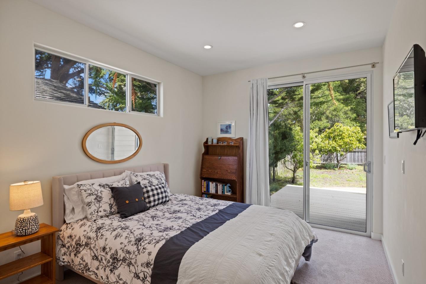 3339 Taylor Road Carmel, CA 93923 - Photo 19 of 27 a bedroom with a bed and a large mirror