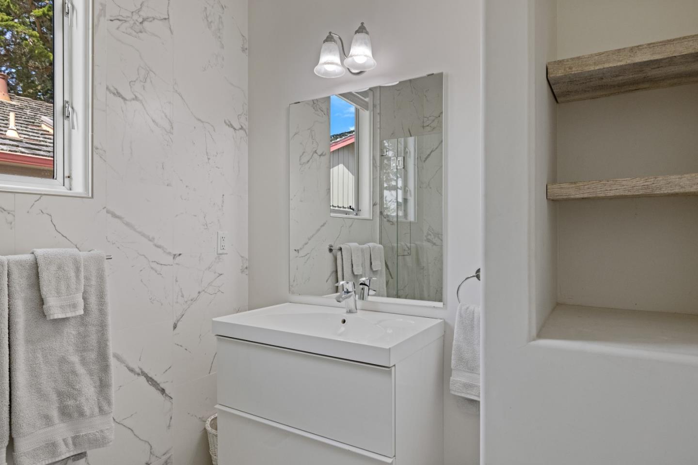 3339 Taylor Road Carmel, CA 93923 - Photo 21 of 27 a bathroom with a sink a light fixture and a mirror