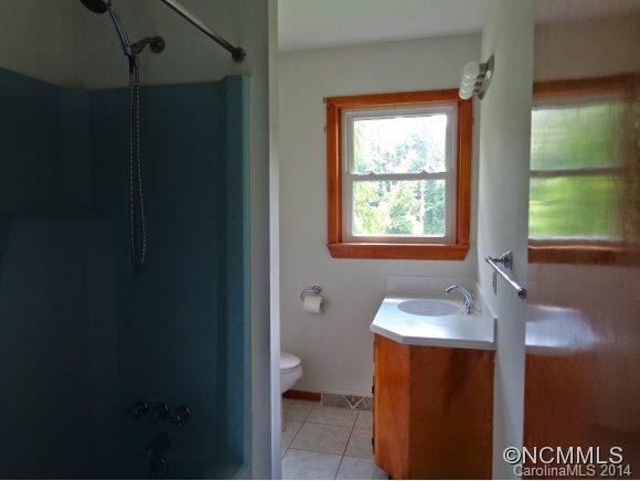 80 Merida Gap Road Canton, NC 28716 - Photo 14 of 18 a bathroom with a granite countertop sink toilet and shower
