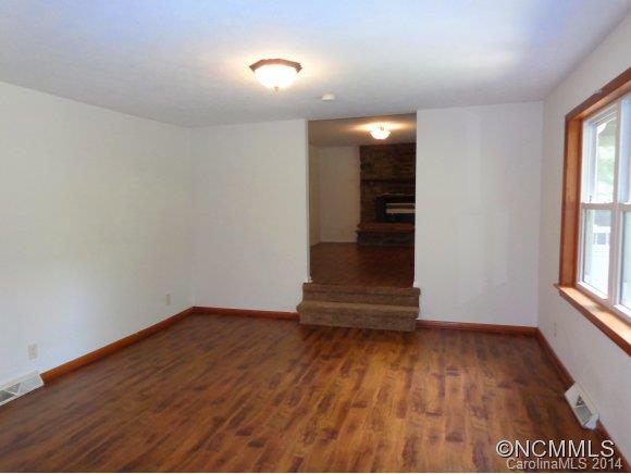 80 Merida Gap Road Canton, NC 28716 - Photo 5 of 18 an empty room with wooden floor and windows