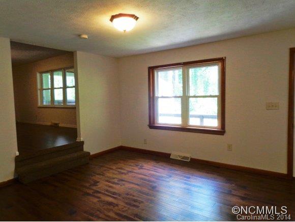 80 Merida Gap Road Canton, NC 28716 - Photo 6 of 18 an empty room with wooden floor and windows