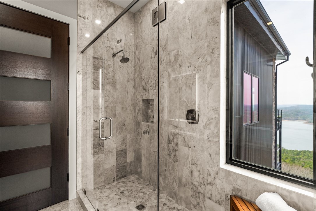 2623 Alum Cave Road Bee Branch, AR 72013 - Photo 41 of 60 Glass-enclosed shower featuring large format stone tile walls and a pebble-finish floor