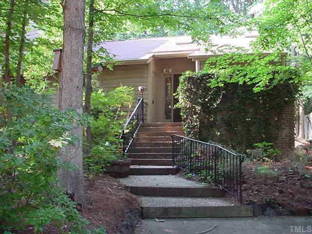 a view of a house with brick walls