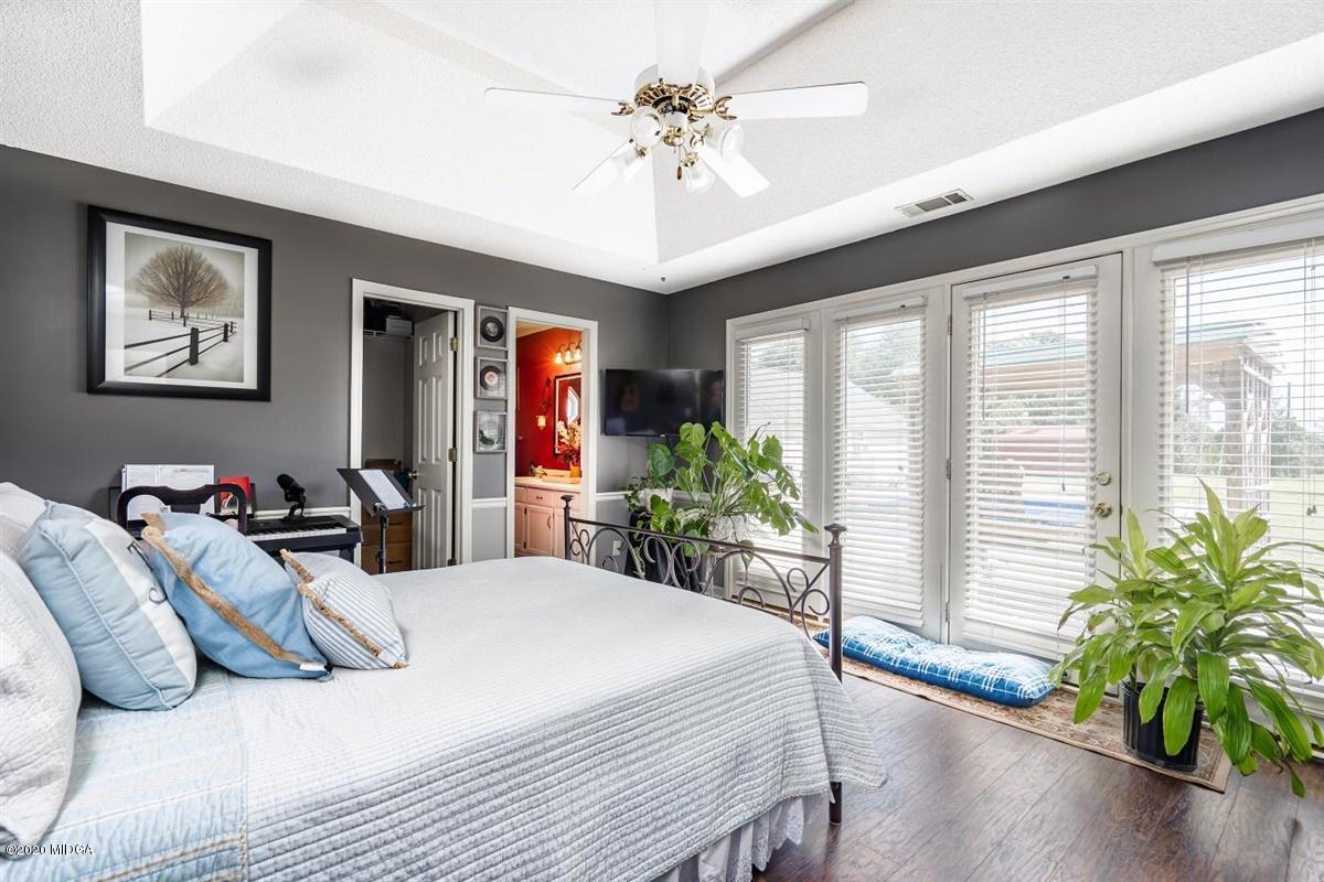 6180 Skipperton Road Macon, GA 31216 - Photo 13 of 37 a bedroom with a large bed and a chandelier