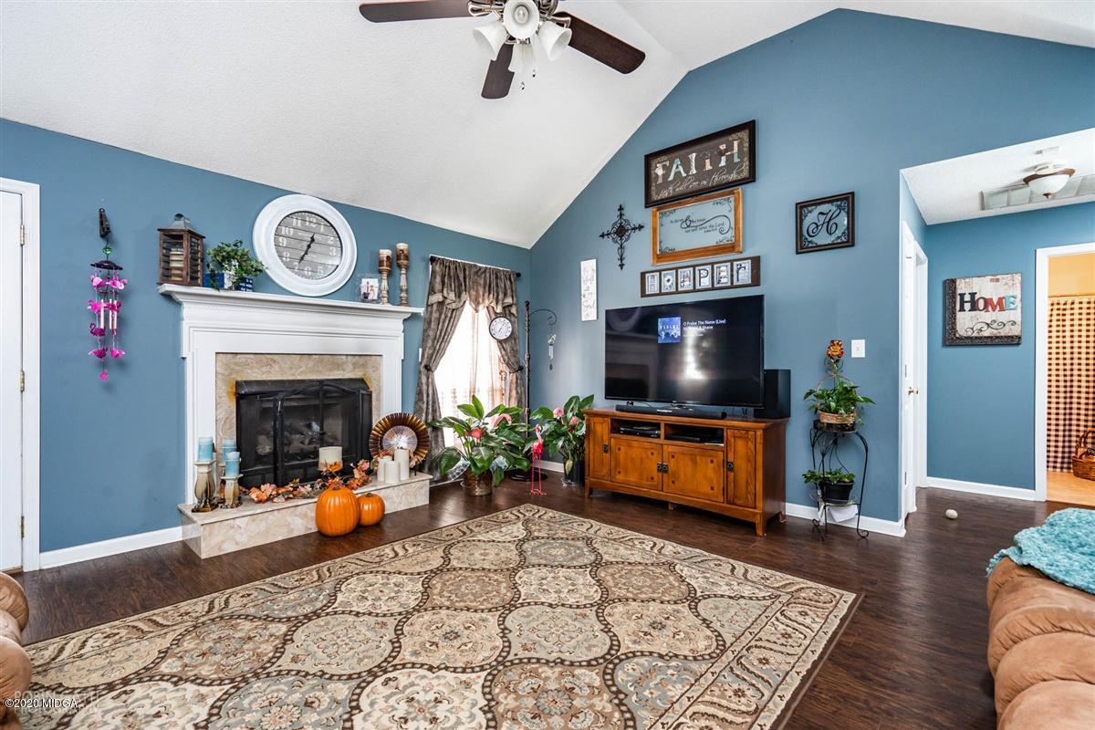 6180 Skipperton Road Macon, GA 31216 - Photo 18 of 37 a living room with furniture and a fireplace