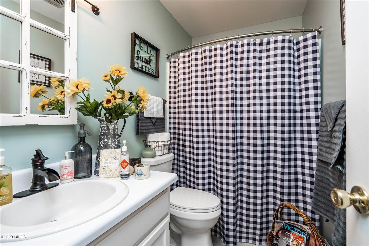 6180 Skipperton Road Macon, GA 31216 - Photo 23 of 37 a bathroom with a sink toilet and a mirror
