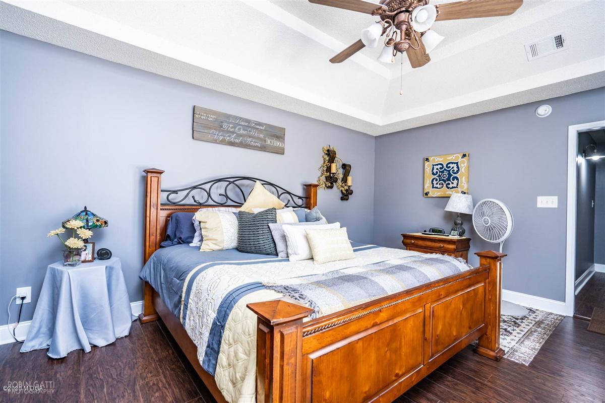 6180 Skipperton Road Macon, GA 31216 - Photo 26 of 37 a bedroom with bed and wooden floor