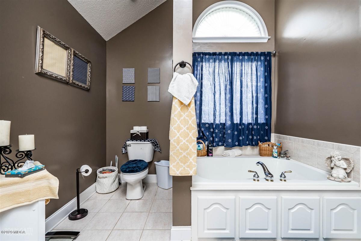 6180 Skipperton Road Macon, GA 31216 - Photo 27 of 37 a bathroom with a toilet sink and mirror