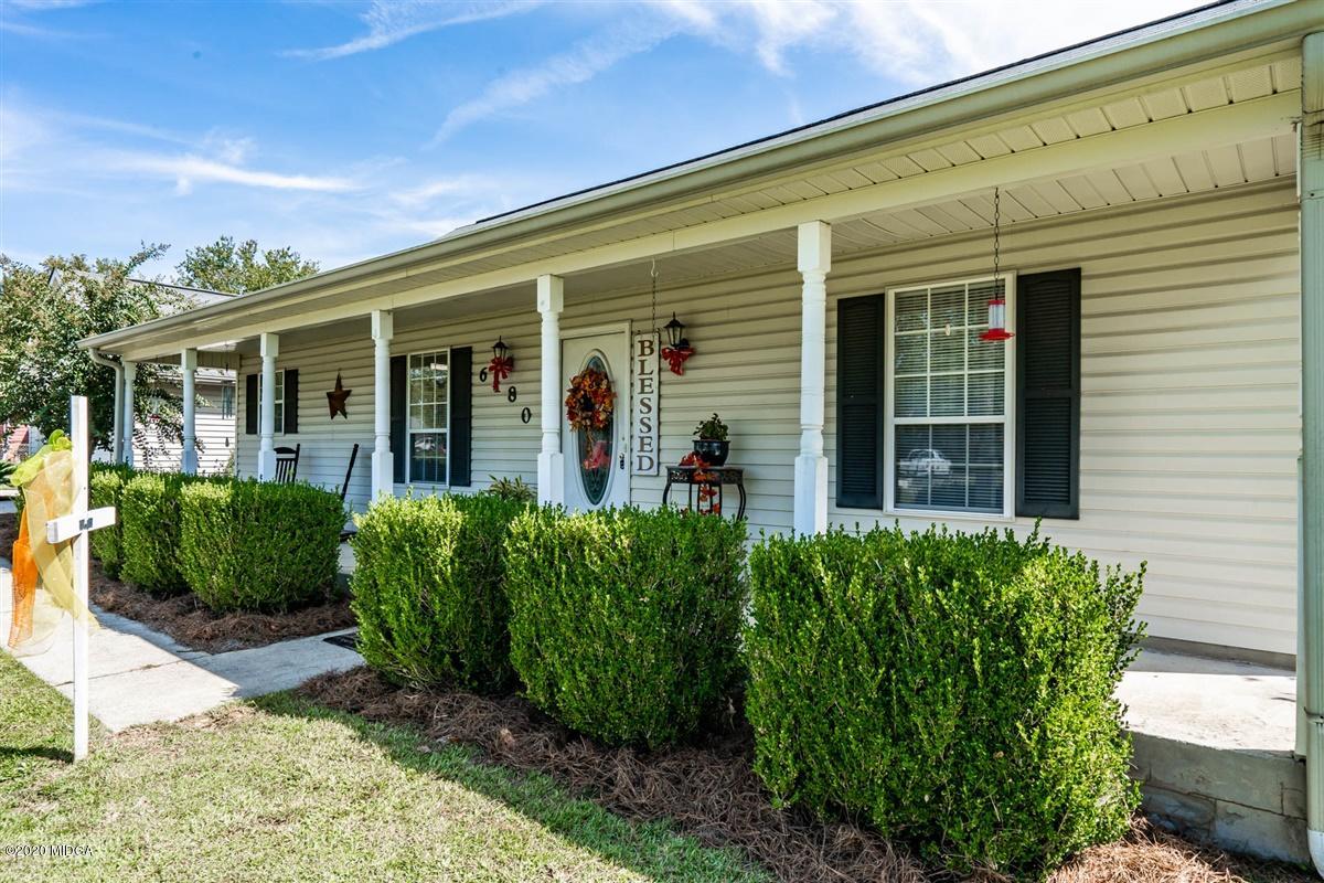 6180 Skipperton Road Macon, GA 31216 - Photo 4 of 37 a view of a house with potted plants and a table and chairs