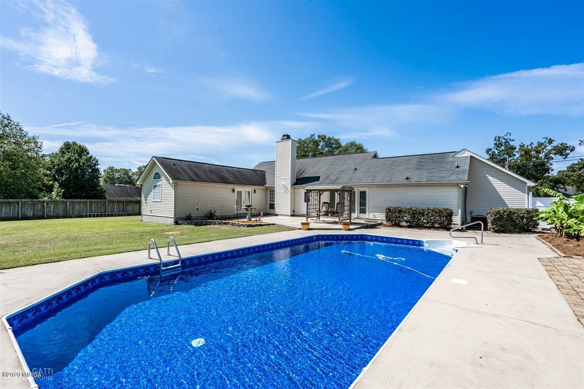 6180 Skipperton Road Macon, GA 31216 - Photo 33 of 37 a swimming pool with outdoor seating and yard