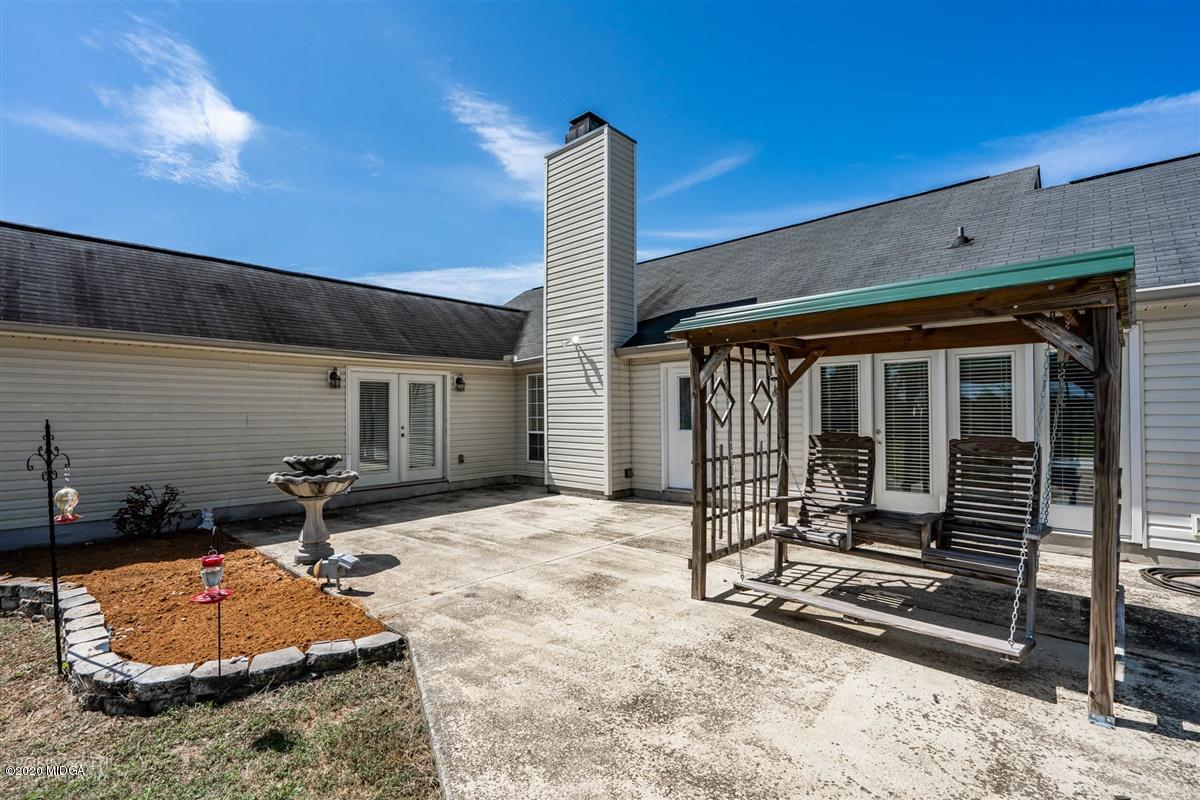 6180 Skipperton Road Macon, GA 31216 - Photo 37 of 37 a backyard of a house with barbeque oven and outdoor seating