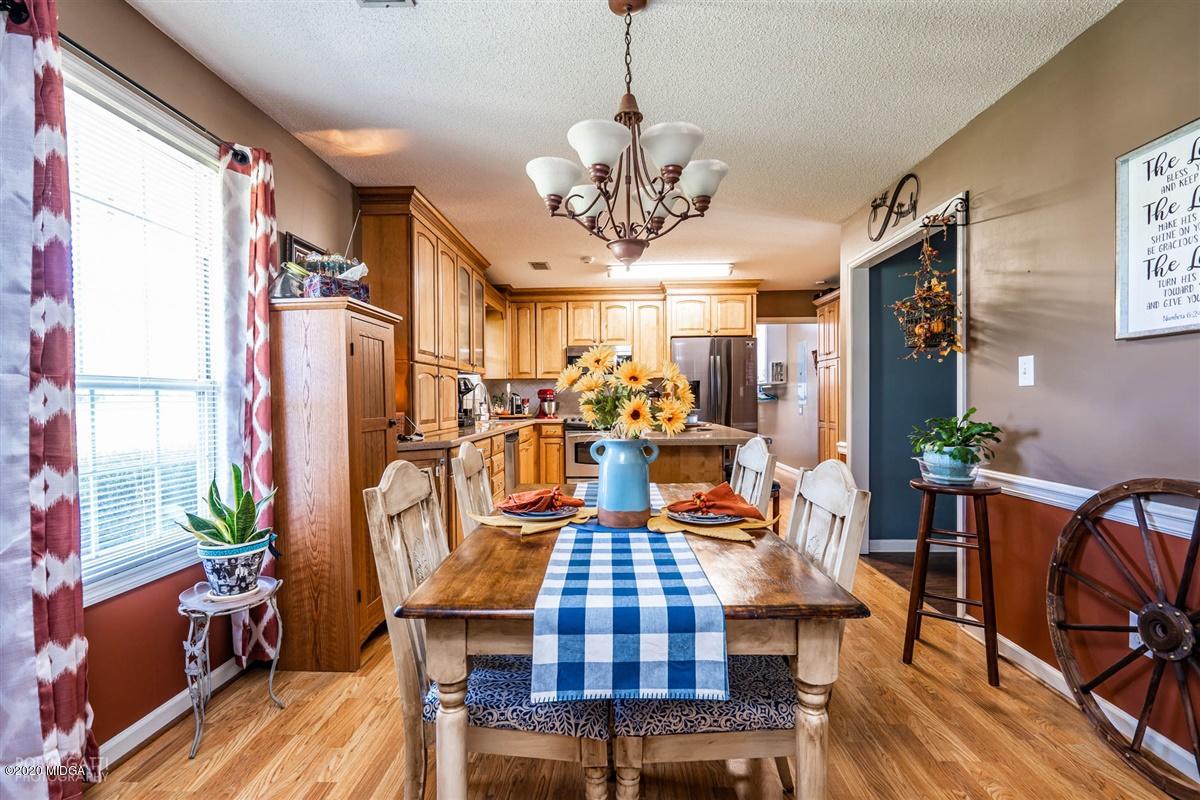 6180 Skipperton Road Macon, GA 31216 - Photo 6 of 37 a view of a dining room with furniture window and wooden floor