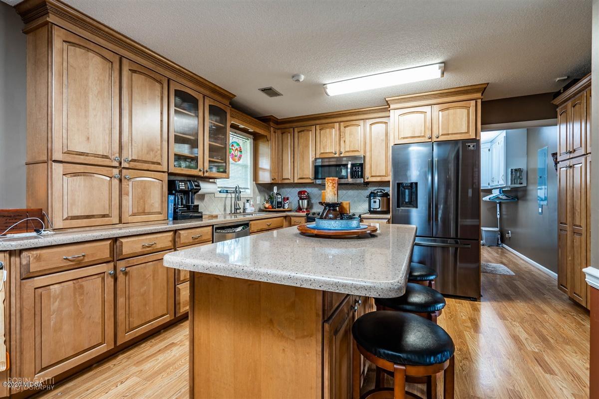 6180 Skipperton Road Macon, GA 31216 - Photo 8 of 37 a kitchen with stainless steel appliances a refrigerator sink and cabinets