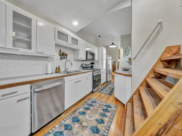 a living room with furniture a flat screen tv and a large window