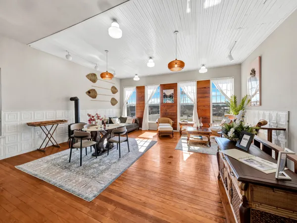 a living room with furniture and a wooden floor