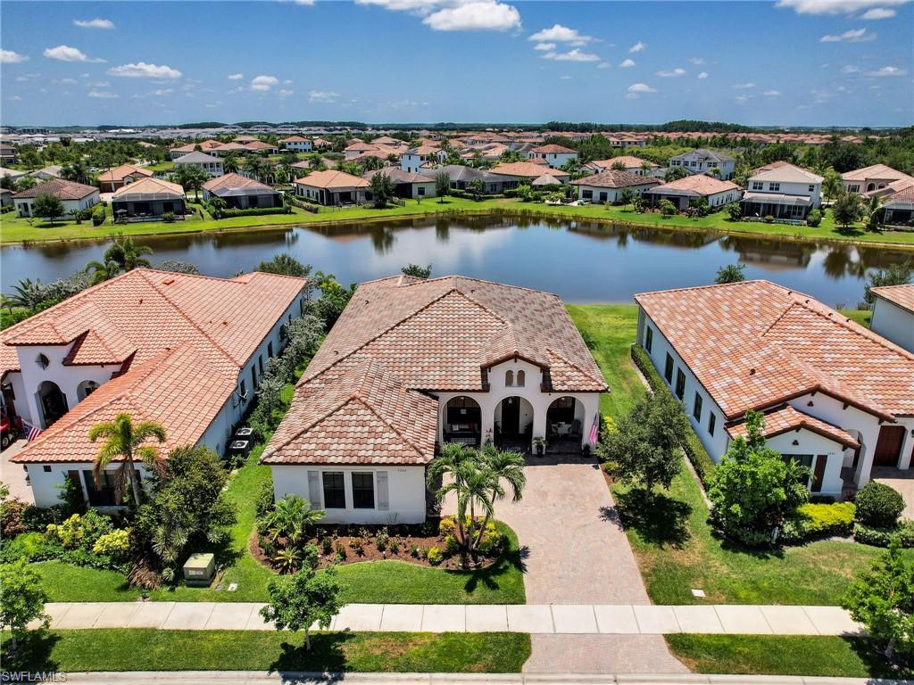 an aerial view of house with yard lake and ocean view