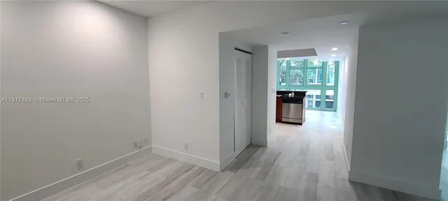 a view of a hallway view with wooden floor and staircase
