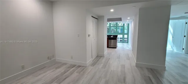 a view of hallway with wooden floor