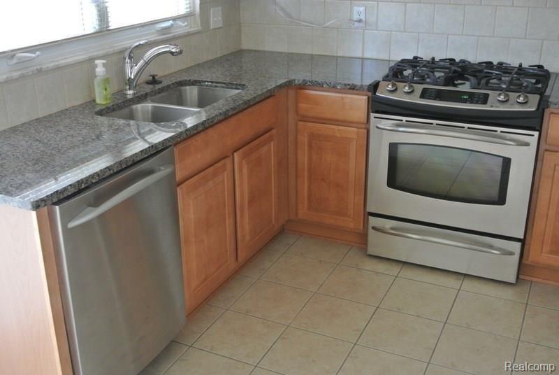 509 Worthington Road Canton, MI 48188 - Photo 6 of 33 Granite Counters, Ceramic Floor in Kitchen