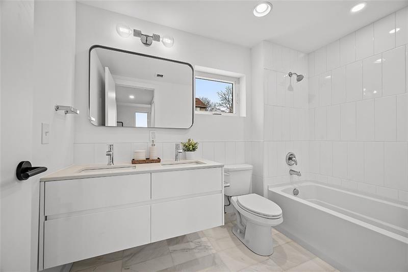 112 Burrows Street Pittsburgh, PA 15213 - Photo 13 of 13 a bathroom with a toilet a sink a tub and mirror