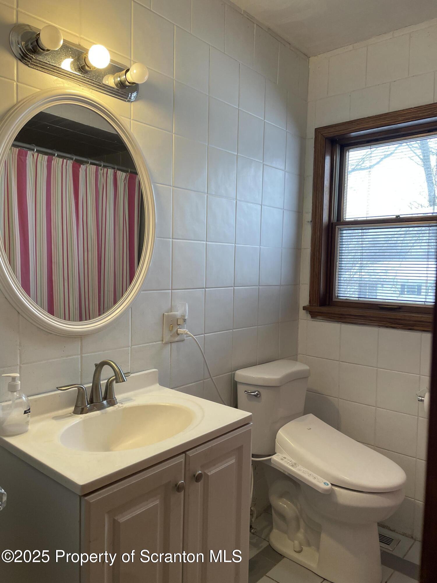 2 Lord Avenue Simpson, PA 18407 - Photo 36 of 62 a bathroom with a sink a toilet and mirror