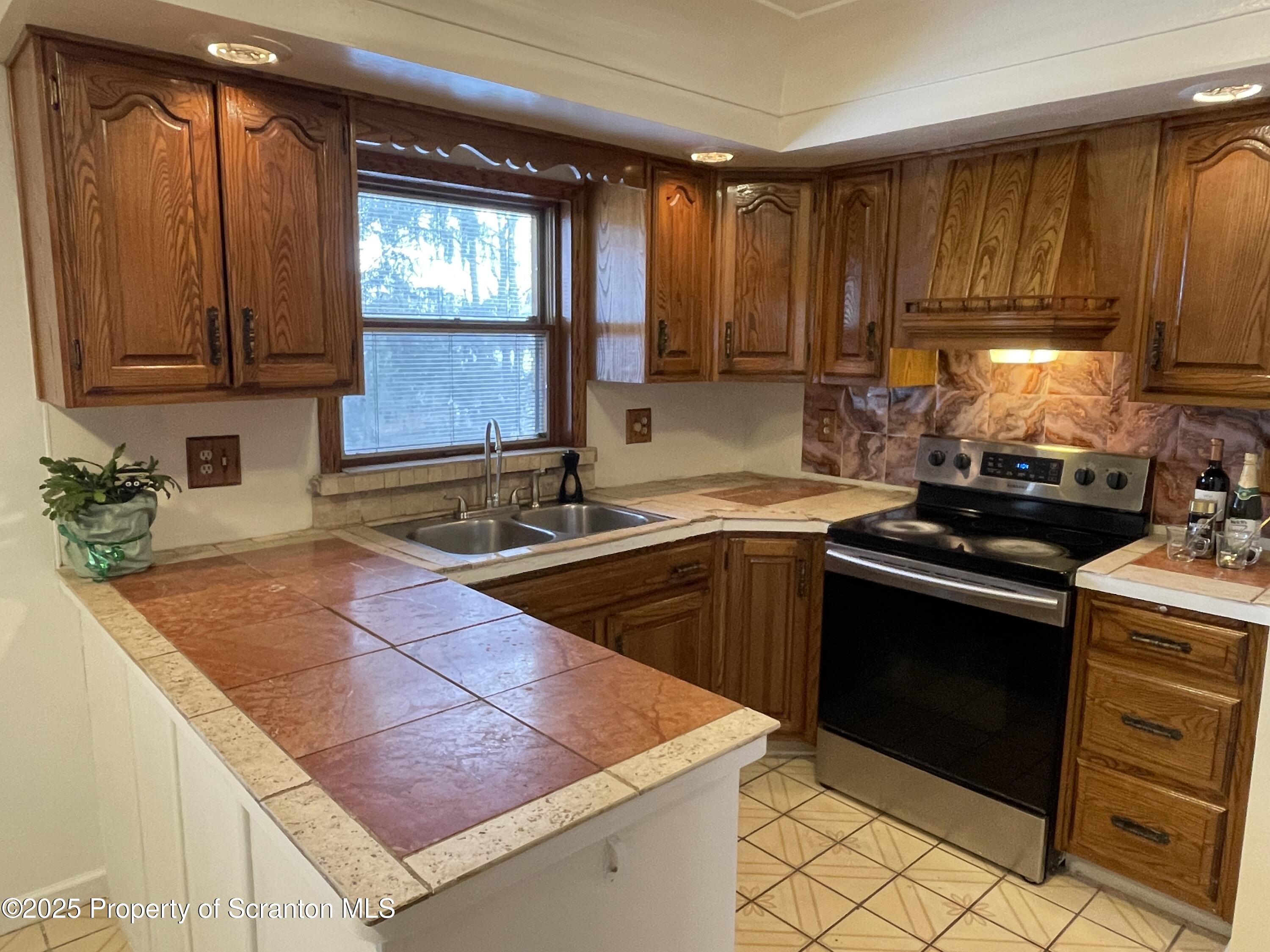 2 Lord Avenue Simpson, PA 18407 - Photo 9 of 62 a kitchen with stainless steel appliances granite countertop a sink stove and microwave