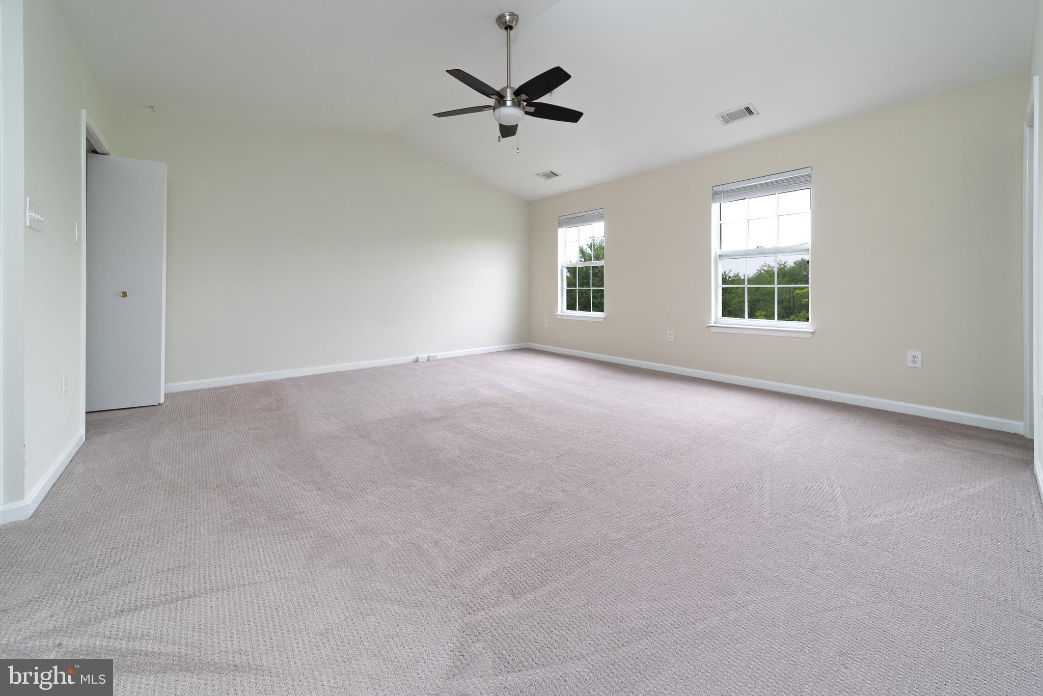 105 Whitestone Way Frederick, MD 21702 - Photo 17 of 19 an empty room with windows and a ceiling fan