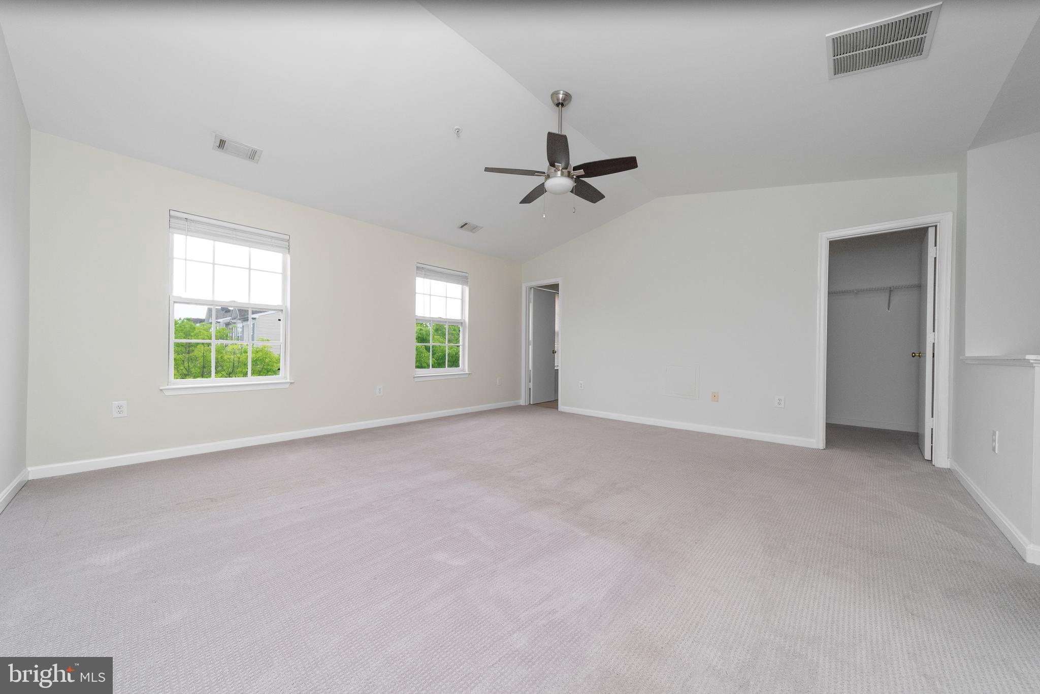 105 Whitestone Way Frederick, MD 21702 - Photo 18 of 19 an empty room with windows and ceiling fan