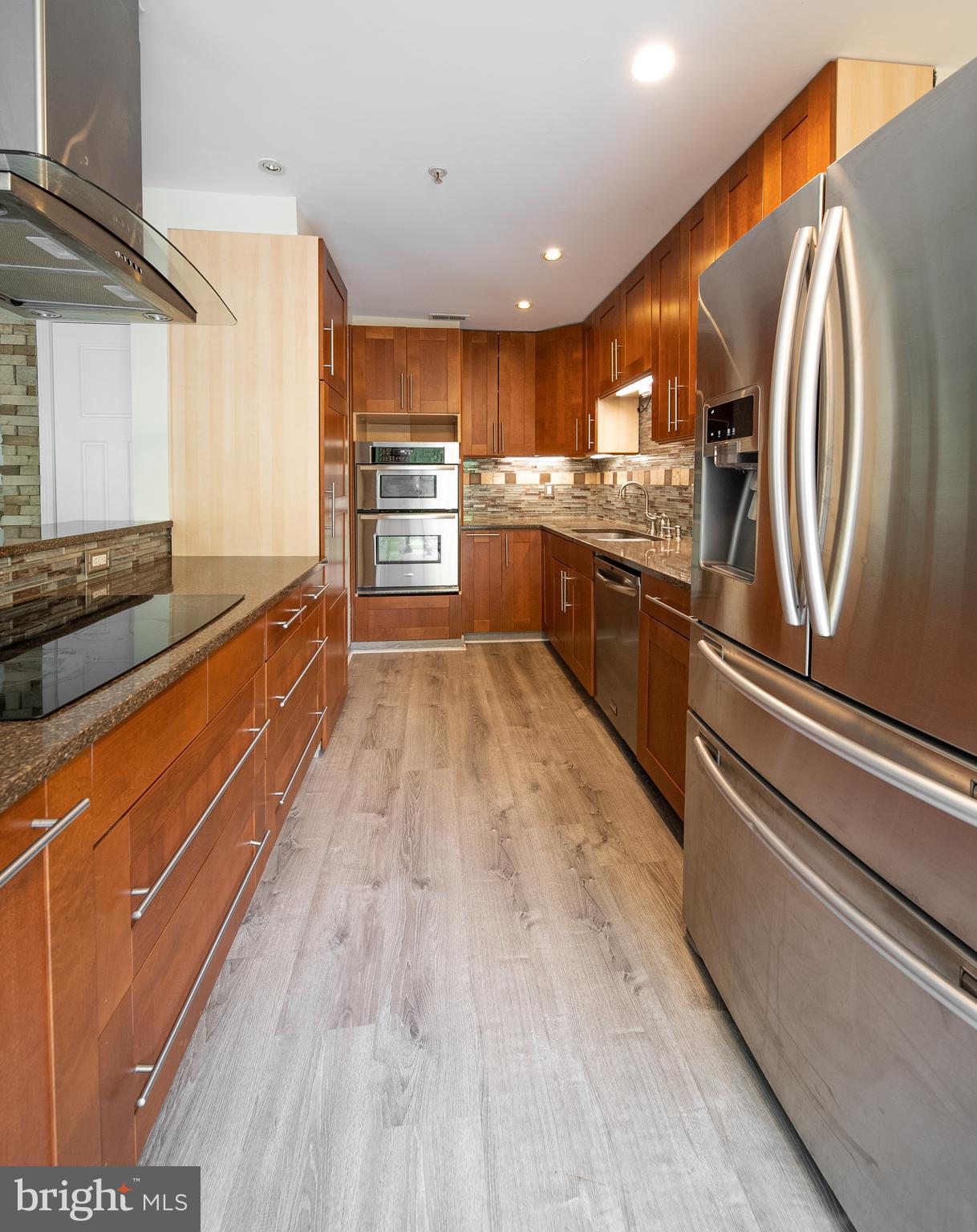 105 Whitestone Way Frederick, MD 21702 - Photo 8 of 19 a large kitchen with stainless steel appliances granite countertop a lot of counter space and wooden floors