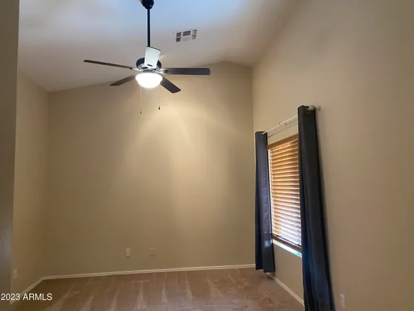a view of entryway with chandelier fan