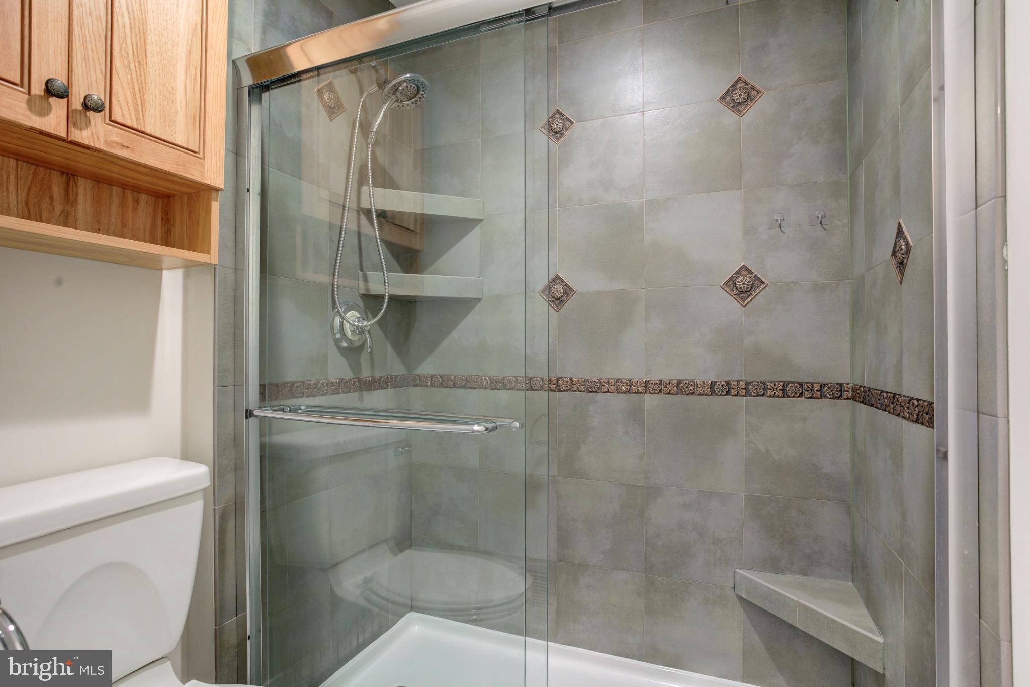 11908 Barrel Cooper Court Reston, VA 20191 - Photo 29 of 40 Sleek modern shower with elegant tile accents.