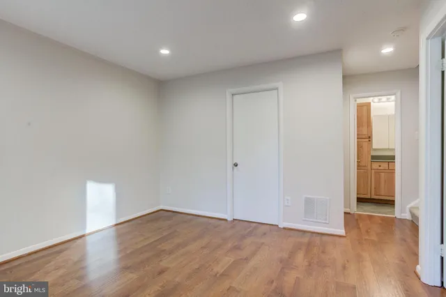 a bathroom with a granite countertop sink a toilet and shower