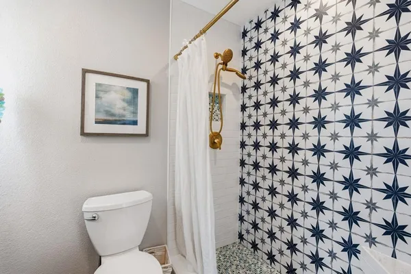 a bathroom with a toilet and shower