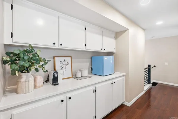a kitchen with a potted plant on the counter and cabinets