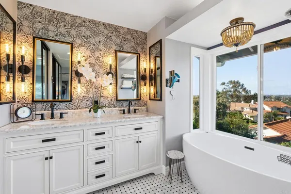 a bathroom with a double vanity sink a toilet a mirror and bathtub