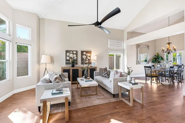a living room with fireplace furniture and a large window