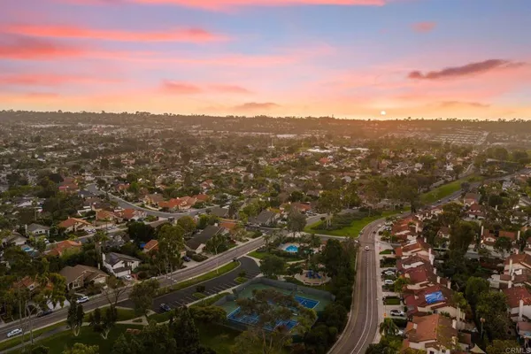 an aerial view of residential houses with city view