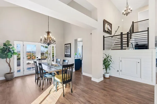 a view of a dining room with furniture wooden floor and chandelier