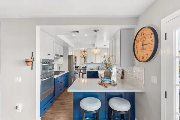 a view of a dining room with furniture and a kitchen